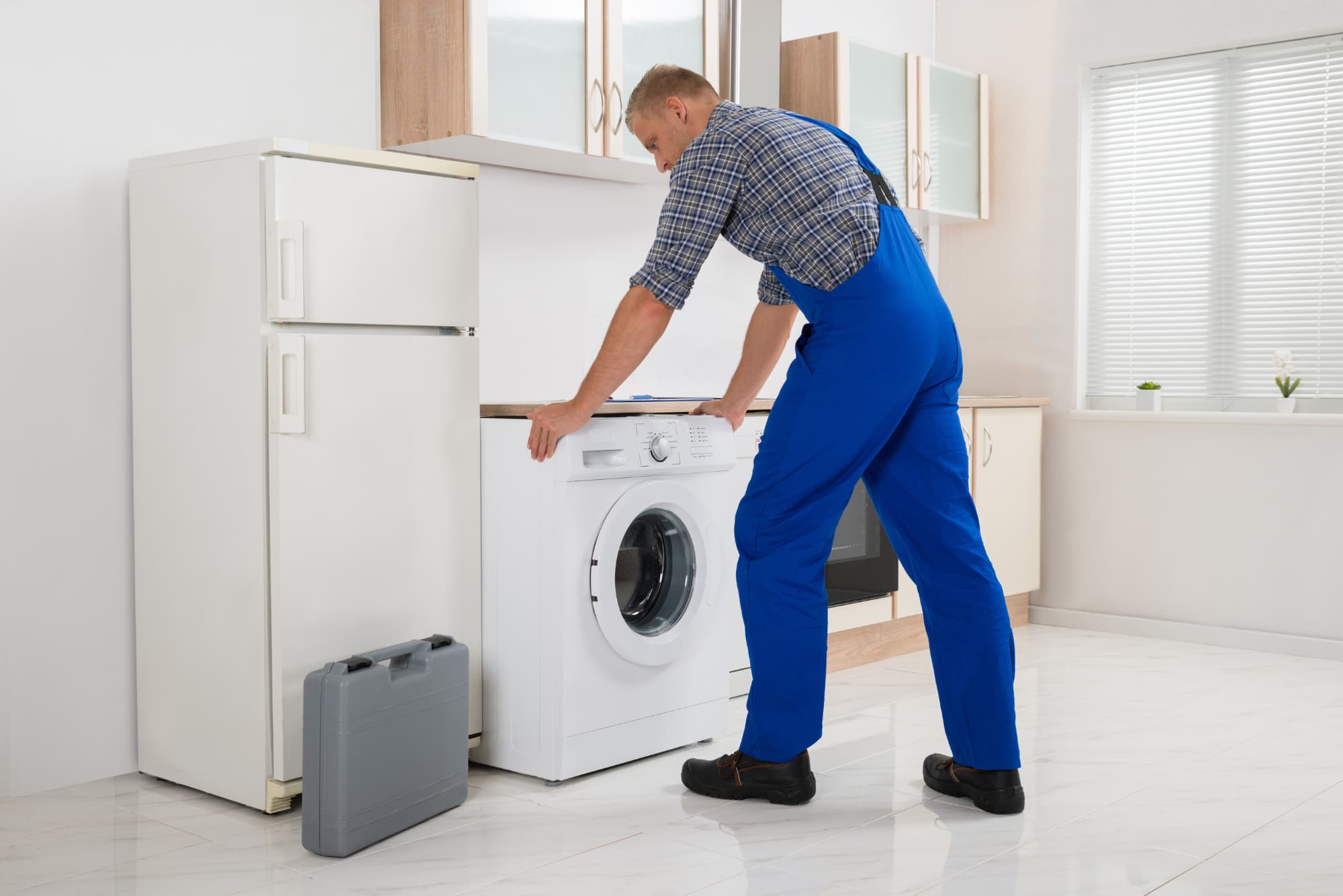 Friendly appliance technician preparing to service a residential washing machine